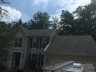 Dark white house with garage roofing window slider