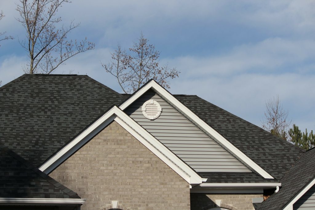 The roofline of a shingle roof in Maryland with debris on roof