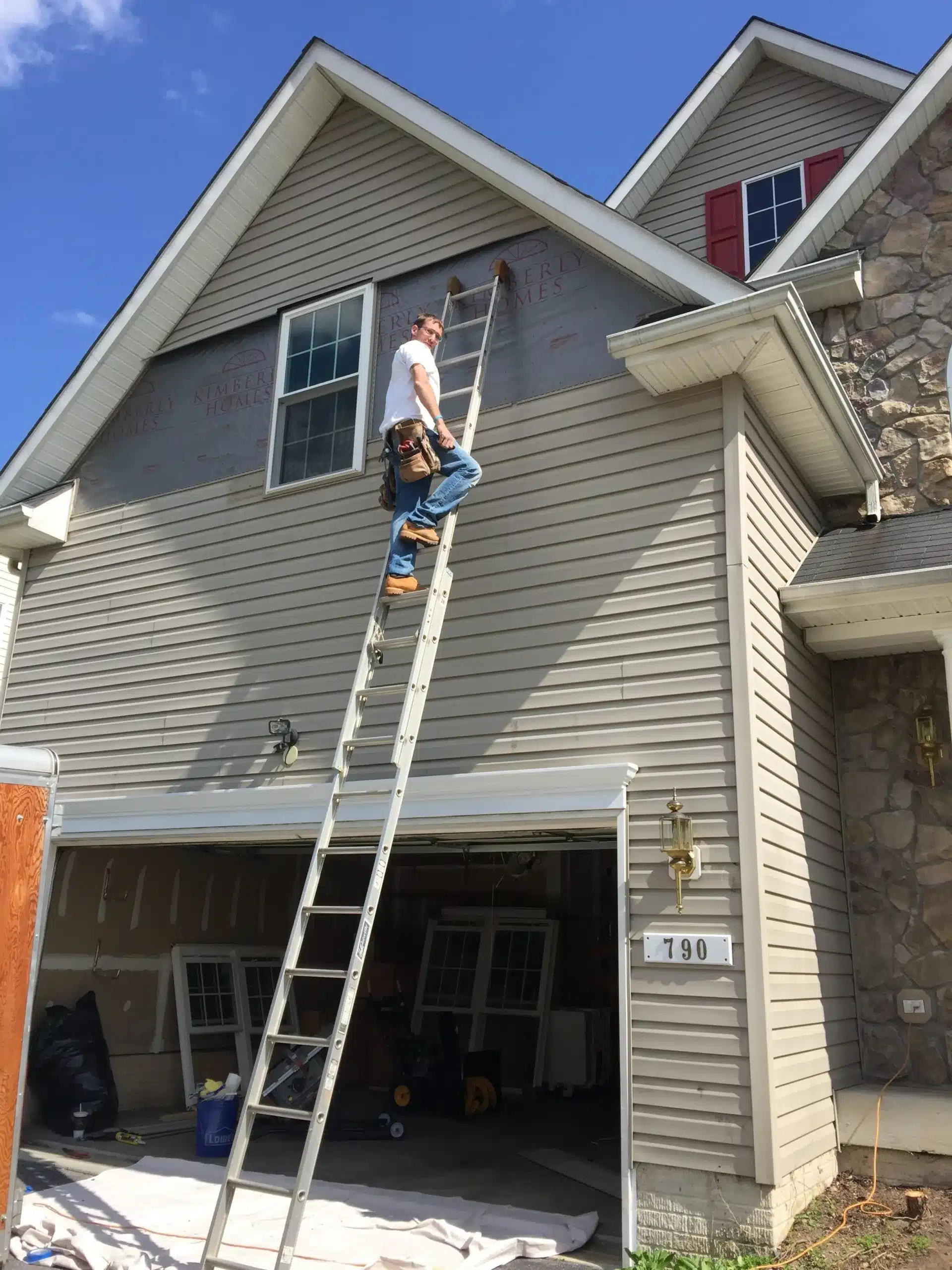 contractor working on home siding scaled 1 jpeg